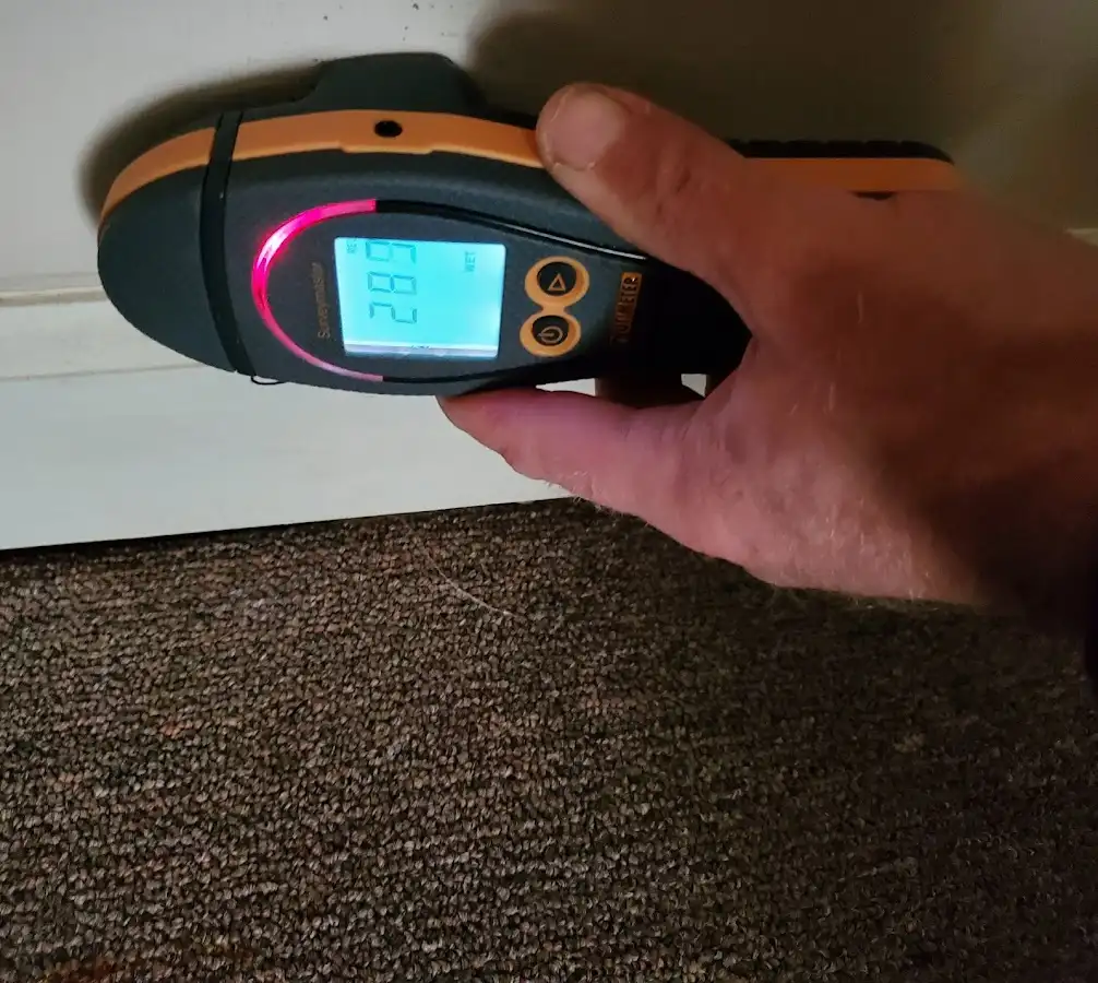 Moisture detection at baseboard during Storm Damage Restoration in Somers Point